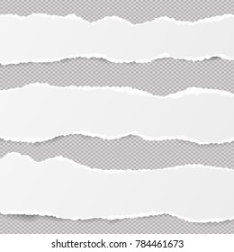 White Ripped Blank Horizontal Note Paper Strips For Text Or Message Stuck On Gray Background.