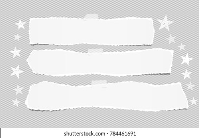 White ripped blank horizontal note paper strips for text or message stuck with sticky tape on gray background with stars