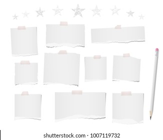 White ripped blank note, notebook paper strips, sheets for text or message stuck with sticky tape on white background with pencil and stars on top