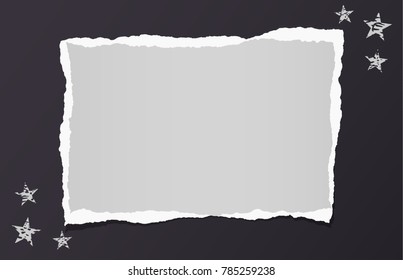 White ripped blank note, notebook paper for text or message stuck on black background with stars.