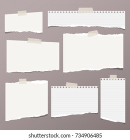 White ripped lined note, notebook paper for message or text stuck with sticky tape on brown background.