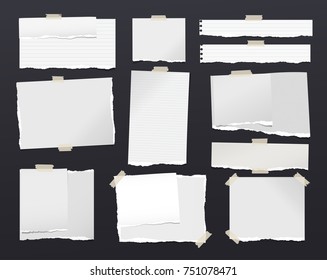 White ripped notebook paper sheets, note for text or message stuck with sticky tape on black background