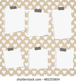 White ripped ruled notebook paper sheets are stuck on pattern of hearts