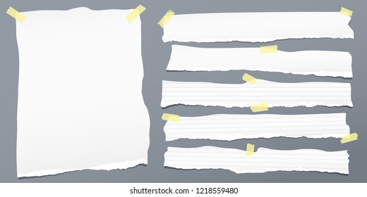 White ripped strips,lined note, notebook paper for text or message are on gray background