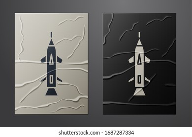 White Rocket icon isolated on crumpled paper background. Paper art style. Vector Illustration