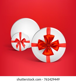 Weiße runde Schachtel mit roter glänzender Schleife. Design-Element für Weihnachten, Geburtstag, Jubiläum, Neujahr, Feiern oder andere Feiern und Veranstaltungen.