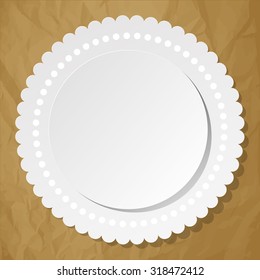 White round label with dots on a crumpled paper brown background.