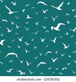 White seagulls flying in the sky seamless pattern