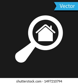White Search house icon isolated on black background. Real estate symbol of a house under magnifying glass.  Vector Illustration
