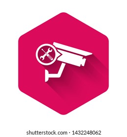 White Security camera with screwdriver and wrench icon isolated with long shadow. Adjusting, service, setting, maintenance, repair, fixing. Pink hexagon button. Vector Illustration