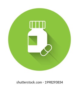 White Sedative pills icon isolated with long shadow background. Green circle button. Vector
