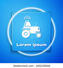 White Self driving wireless tractor on a smart farm icon isolated on blue background. Smart agriculture implement element. Blue square button. Vector Illustration