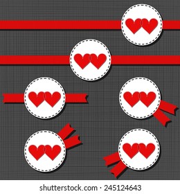 white sewed red hearts in love label Valentine's Day badge set with red ribbon on dark background