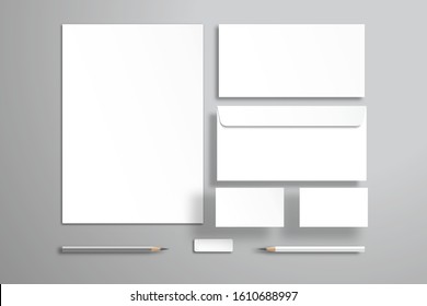 White sheet of paper or blank, two envelopes, two business cards, pencils and an eraser. Realistic mockup for design with objects that are at different levels from the surface