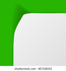 White sheet of paper with curved corner and with shadow on green background