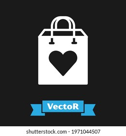 White Shopping bag with heart icon isolated on black background. Shopping bag shop love like heart icon. Valentines day symbol.  Vector