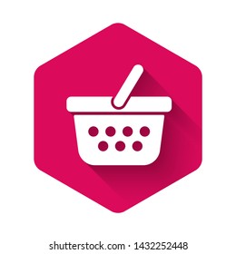White Shopping basket icon isolated with long shadow. Online buying concept. Delivery service sign. Shopping cart symbol. Pink hexagon button. Vector Illustration