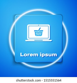 White Shopping basket on screen laptop icon isolated on blue background. Concept e-commerce, e-business, online business marketing. Blue square button. Vector Illustration
