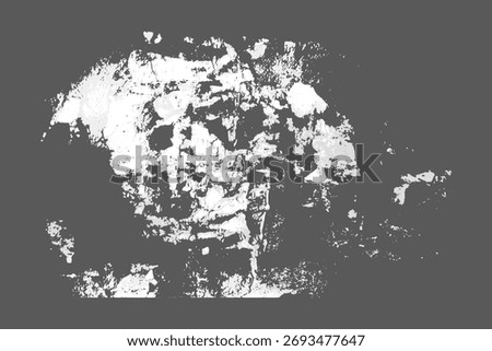 White shreds of torn and ripped paper with adhesive residue on wall
