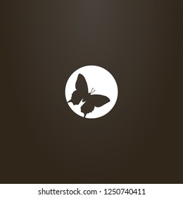 white sign on a black background. vector flat art negative space round sign of a butterfly 