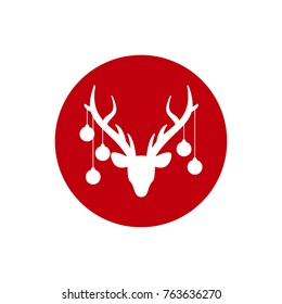 White silhouette of deer head with antlers and with christmas tree toy balls on horns in red circle. vector flat icon isolated on white background. Christmas card