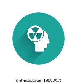 White Silhouette of a human head and a radiation symbol icon isolated with long shadow. Green circle button. Vector Illustration