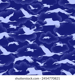 white silhouettes of cranes on the background of unusual clouds drawing in the dot technique. Seamless pattern, repeating background in two colors - blue and white