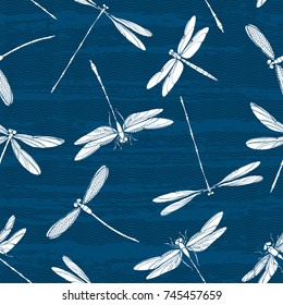 White silhouettes of dragonflies on a textured background. Seamless vector pattern. Art nature background.
