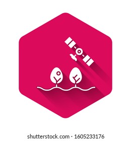 White Smart farm with drone control and tree icon isolated with long shadow. Innovation technology for agricultural company. Pink hexagon button. Vector Illustration