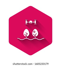 White Smart farm with drone control and tree icon isolated with long shadow. Innovation technology for agricultural company. Pink hexagon button. Vector Illustration