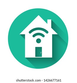 White Smart home with wi-fi icon isolated with long shadow. Remote control. Green circle button. Vector Illustration