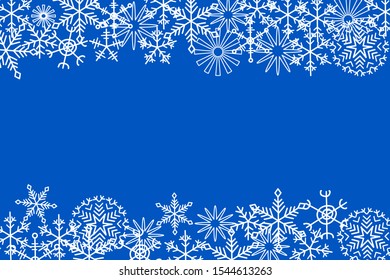 White snow flakes drawing isolated on blue background. Beautiful backdrop for decorating with copy space for your text.