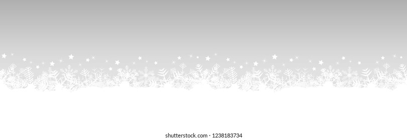 white snow flakes on bottom side and silver colored christmas background