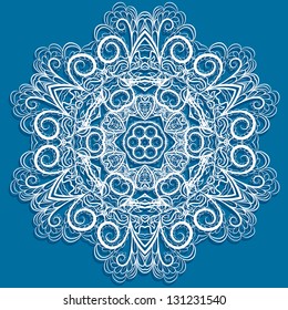 White snowflake with abstract floral pattern on blue background. Round pattern looks like crocheting  handmade lace.