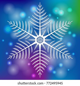 White snowflake on blue background with bokeh. Christmas decoration