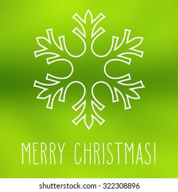 White snowflake over square abstract smooth blur background with hand written Christmas greetings.