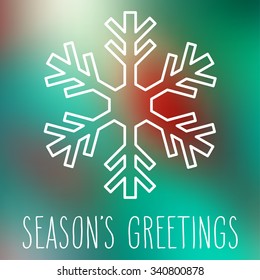 White snowflake over square abstract smooth blur background with hand written season's greetings.