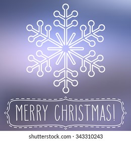White snowflake over square abstract smooth blur background with hand written Christmas greetings in a frame.