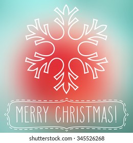 White snowflake over square abstract smooth blur background with hand written Christmas greetings in a frame.