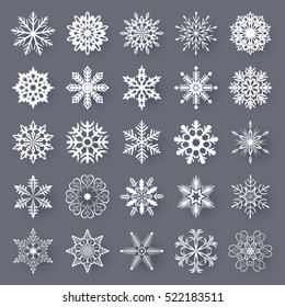 White snowflake shapes set isolated on grey background. Vector collection of snow flakes silhouettes.