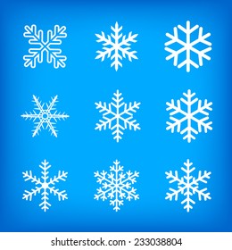 White snowflakes collection on blue background.