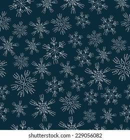 White  snowflakes on blue background seamless pattern