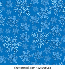 White  snowflakes on blue background seamless pattern