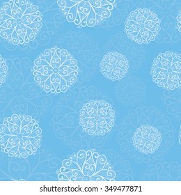 White snowflakes on a blue background. Winter seamless pattern