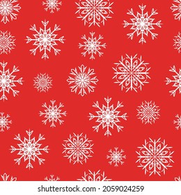 White snowflakes seamless pattern on red background.