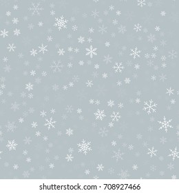 White snowflakes seamless pattern on light grey Christmas background.