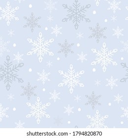 White snowflakes seamless pattern. Snow crystals on light blue background. Great for winter fabric, textile, Christmas wrapping paper, scrapbooking. Surface pattern vector design.