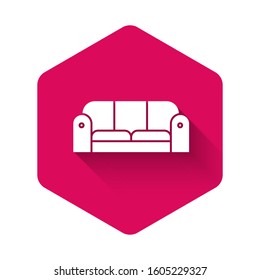 White Sofa icon isolated with long shadow. Pink hexagon button. Vector Illustration