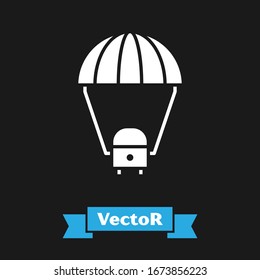 White Space capsule returning to earth via parachute icon isolated on black background.  Vector Illustration