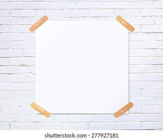 White square blank piece of paper taped to the white brick wall with beige plaster, vector illustration